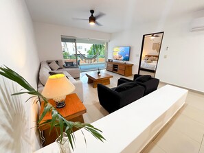 Family Apartment, 2 Bedrooms, Pool View, Poolside | Living area | Fireplace - Relajate hermoso jardín y 2 piscinas (Puerto Aventuras)
