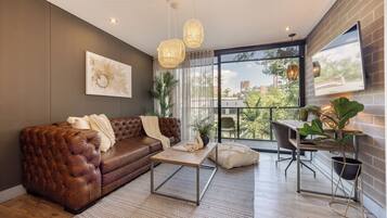 Apartment, 2 Bedrooms | Living area | 55-inch Smart TV with digital channels, toys