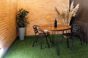 Enjoy dining and socializing in this charming corner setting with a round table and comfortable seating for four.