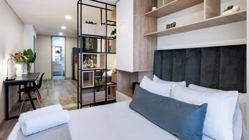 Escritorio, tabla de planchar con plancha y ropa de cama