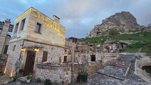 A stone building with a sign reading 'PATINA.' - Patina Cappadocia (Nevsehir)