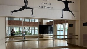 A dance studio with wooden floors, mirrors, and a motivational quote on the wall. - Taguig Grand Suite - Cozy Modern Apartment (Taguig)
