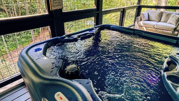 A hot tub with a wooden deck and a view of trees. - 8 miles to Dollywood-Hot Tub-Game Room-King & Queen Beds-Sleeps up to 6 (Sevierville)