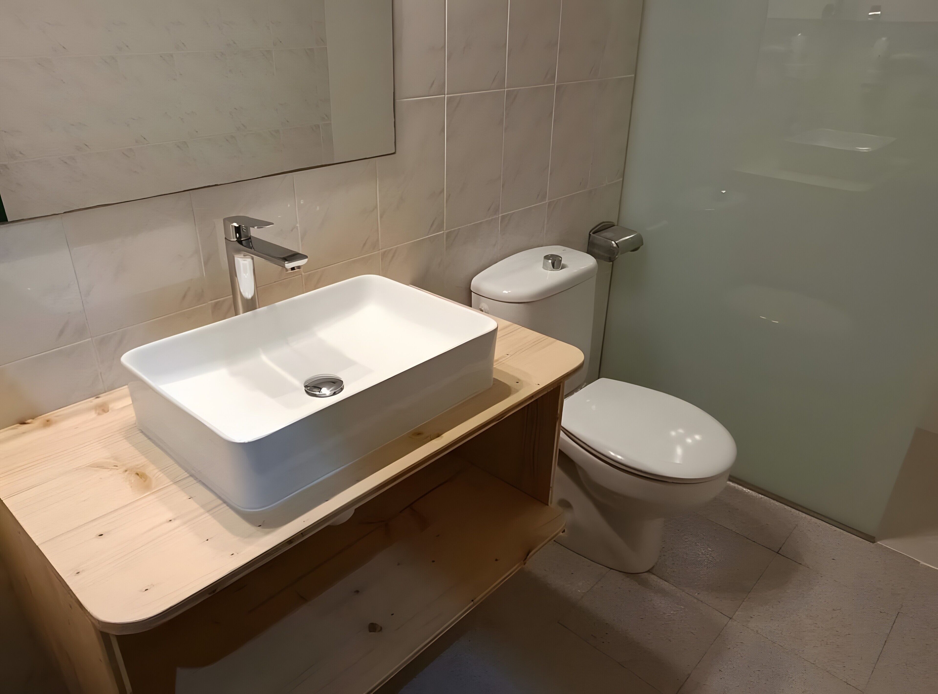 A bathroom with a white sink, toilet, and shower.
