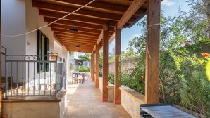 A covered outdoor area with a grill, a patio with tables and chairs, and a view of greenery. - Villa 'La Collina' with Private Terrace, Wi-Fi and Air Conditioning (Galatone)