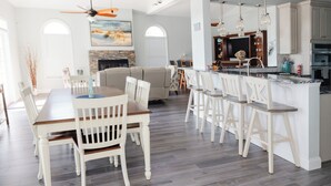 A spacious kitchen with a central island, white cabinetry, and pendant lighting. - Luxurious Large Home on Gulf of Mexico w/Private 30' Dock (Englewood)