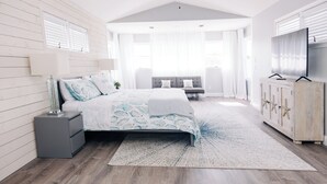 A bedroom with a bed, nightstands, a TV, and a wardrobe. - Luxurious Large Home on Gulf of Mexico w/Private 30' Dock (Englewood)