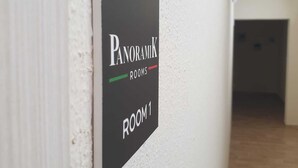 A sign indicating "Panoramic Rooms" on a wall. - Panoramik  (Acri)