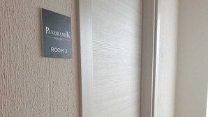A door with a sign indicating "PanoramiK Rooms ROOM 3". - Panoramik  (Acri)