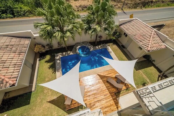 A modern house with a swimming pool, a wooden deck, and a white fence. - Close to Flamingo-Conchal Beach First floor Condo! (Provincia de Guanacaste)