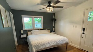 A bedroom with a bed, a ceiling fan, a window, and a door. - mi casa es TU casa (WEST) (Upland)