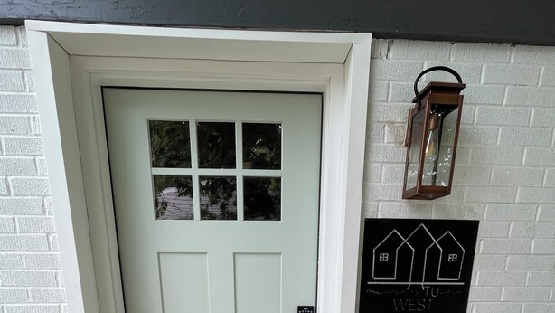 A white door with a window, a mailbox, and a welcome mat. - mi casa es TU casa (WEST) (Upland)