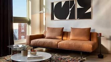 A modern living room with a sofa, a coffee table, and a rug.