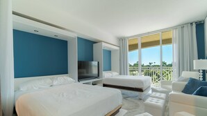 A hotel room with two beds, a TV, a balcony with a view, and a white color scheme.