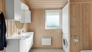A modern bathroom with wooden panel walls, a window, a sink, a mirror, a toilet, and a washing machine. - Nice home in Væggerløse with WiFi (Væggerløse)