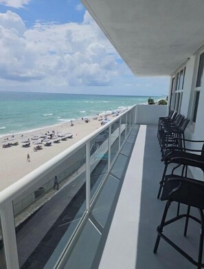 A balcony with a view of a beach and ocean. - Panoramic Beachfront Views! (Hollywood)