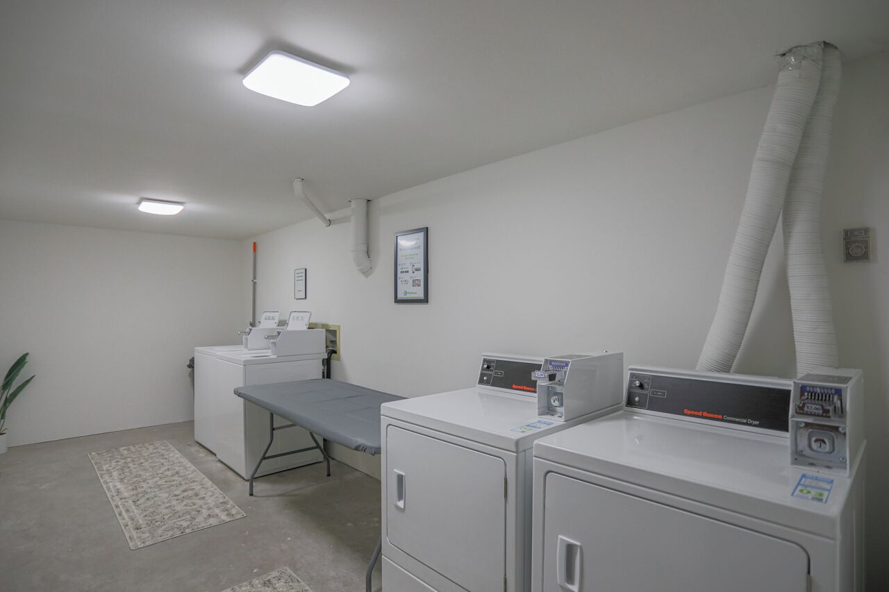 A clinical setting with medical equipment, a patient bed, and a sterilizer.