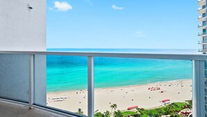 A balcony with a view of a beach and ocean. - 1910 International  Resort Deluxe 2 Queen  Ocean Front (Sunny Isles Beach)