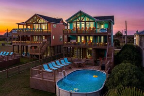 A two-story building with a pool and outdoor seating area.