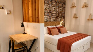 Un dormitorio con cama, escritorio y silla.