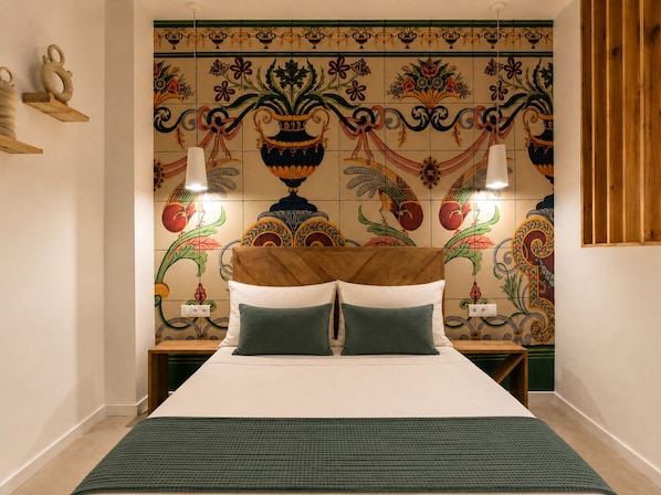 A bedroom with a bed, two nightstands, and a decorative wall with tiles.