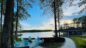 A lakeside patio with outdoor seating and a covered area.