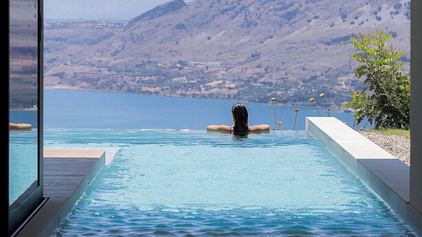 Ein Pool mit Blick auf Berge und einen klaren Himmel.
