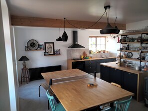Enjoy cooking in this well-equipped kitchen with a central island, gas stove, and sink.