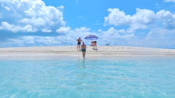 On the beach, white sand, beach towels