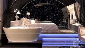 A luxurious bedroom with a large bed, a bathtub, and a starry night sky view. - Ngan Le Mot Dem Hotel (Ho Chi Minh City)