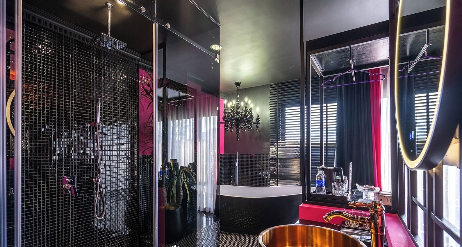 A modern bathroom with a large mirror, a bathtub, and a sink.