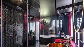 A modern bathroom with a large mirror, a bathtub, and a sink.