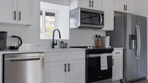 Fridge, stovetop, dishwasher, coffee/tea maker