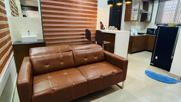 Family Villa | Living area | 32-inch LCD TV with cable channels