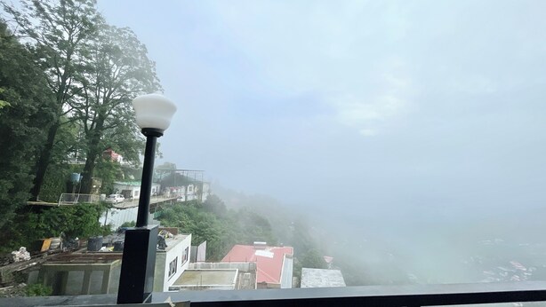 A foggy view of a residential area with buildings and trees. - HOTEL PETAL - PURI (Puri)