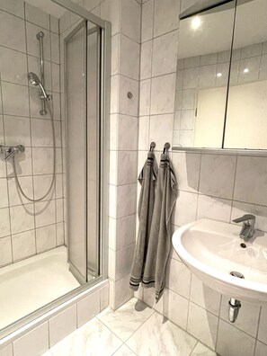 Shower, hair dryer, towels, soap