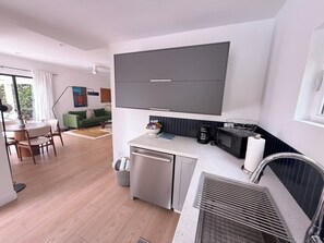 A compact kitchen with a microwave, coffee maker, and a small refrigerator. - The Knot - The Ultimate Palm Springs Bungalow (Palm Springs)