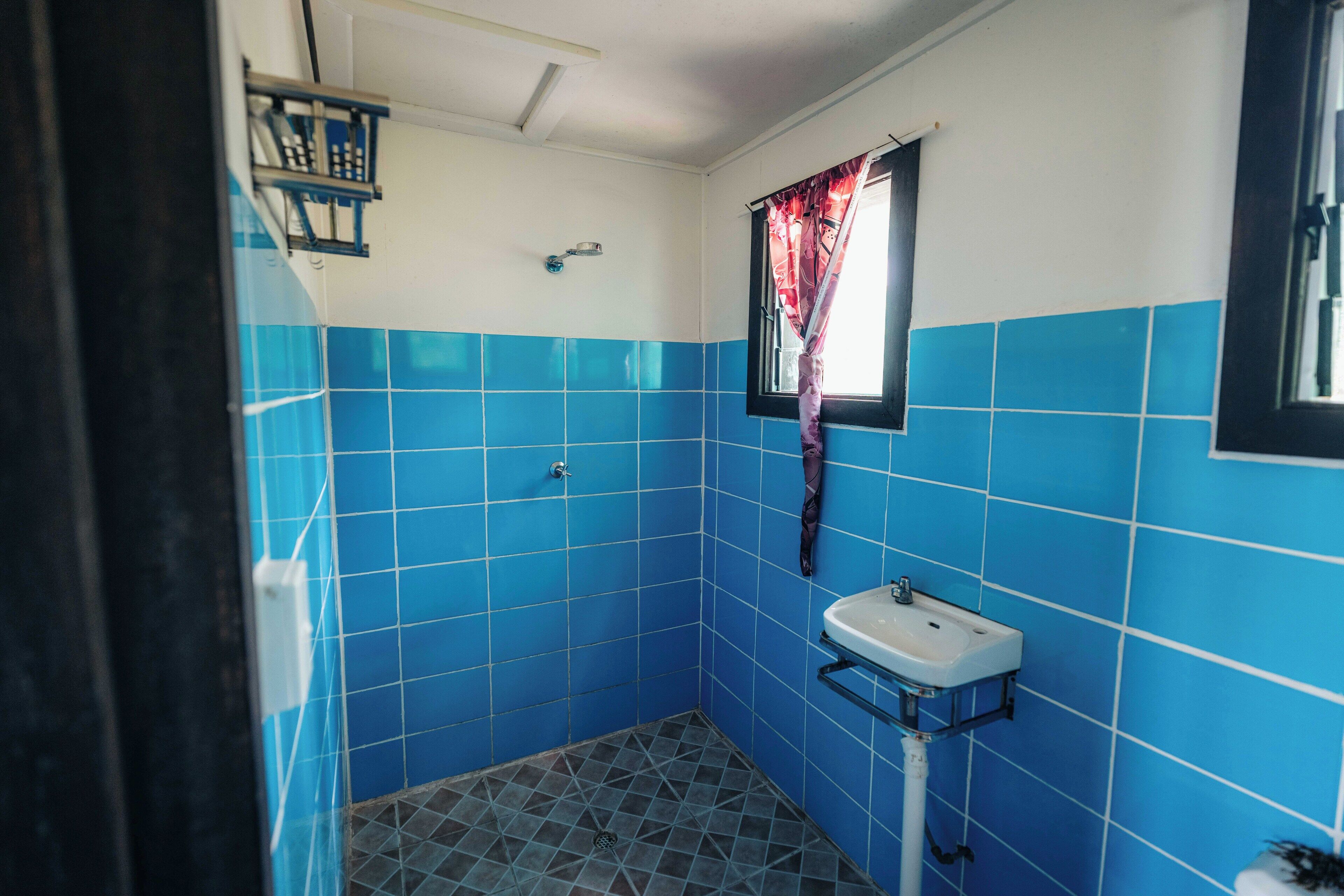 Basic Single Room, Balcony, Lagoon View | Bathroom | Shower, towels, soap, toilet paper