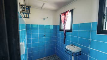 Basic Single Room, Balcony, Lagoon View | Bathroom | Shower, towels, soap, toilet paper