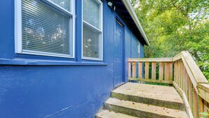 A blue building with a wooden staircase leading to a door. - Walk to Dtwn Branson: Pet-friendly Home! (Branson)
