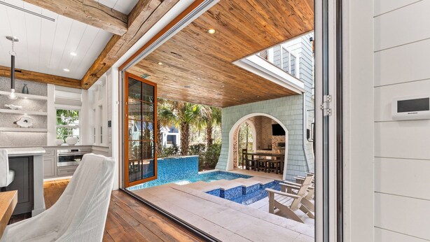 A modern kitchen with white cabinets and a wooden ceiling. - Tranquility|Private Community Beach Access|Pool|Golf Cart|Game Room (WaterSound)