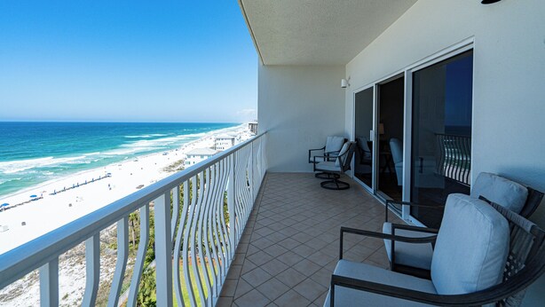 Een balkon met uitzicht op het strand en de oceaan.