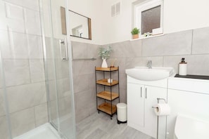 Shower, hair dryer, towels, shampoo