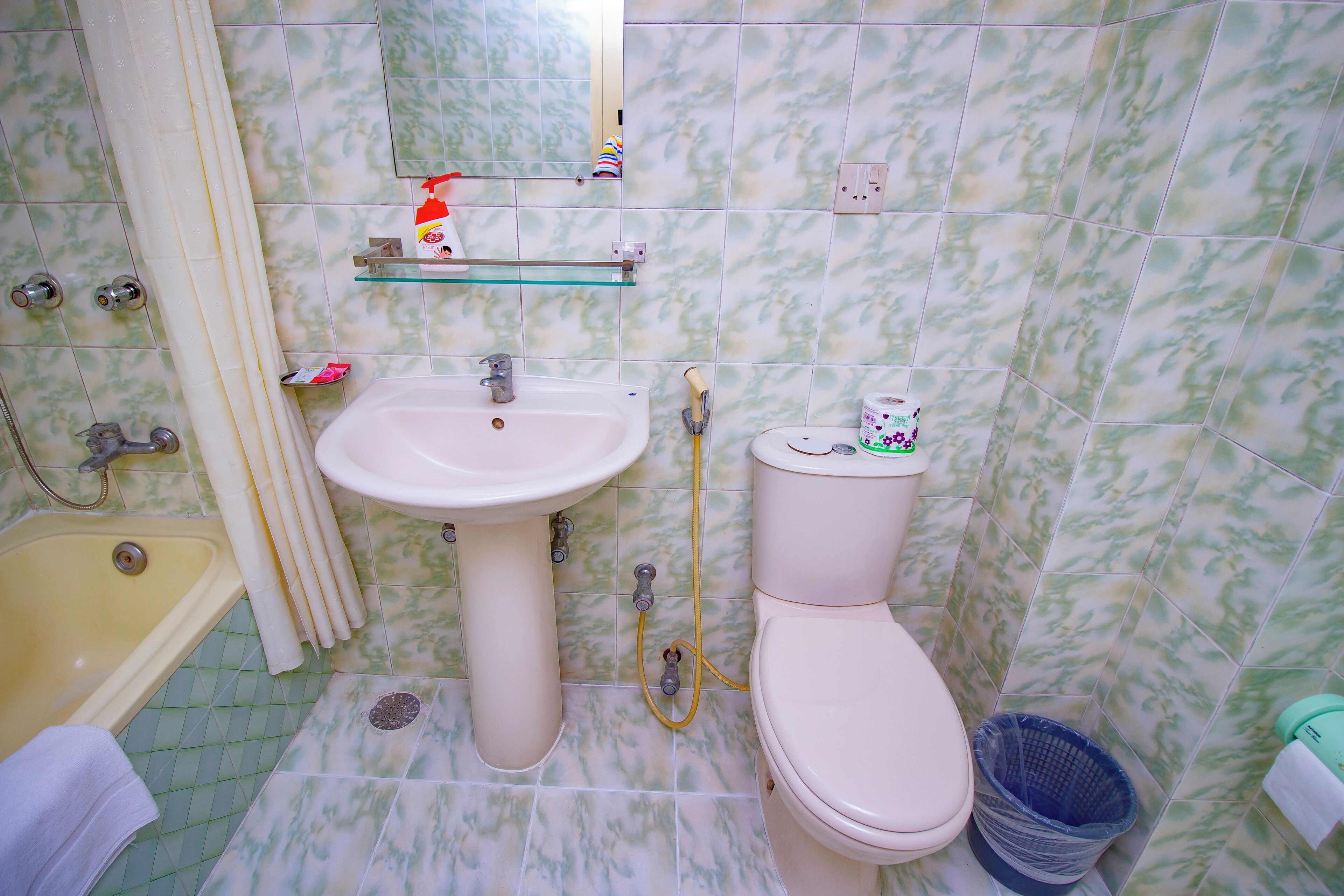 A bathroom with a bathtub, sink, toilet, and shower.