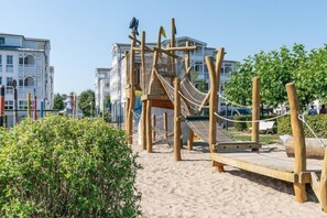 Children can play on the rope bridge and slide in this outdoor play area.