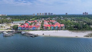 A coastal resort with colorful buildings, a marina, and a beach. - 🏖️🏝️Waterfront-Inlet Beach-Pool & Hot Tub-Red Retreat (Pensacola)