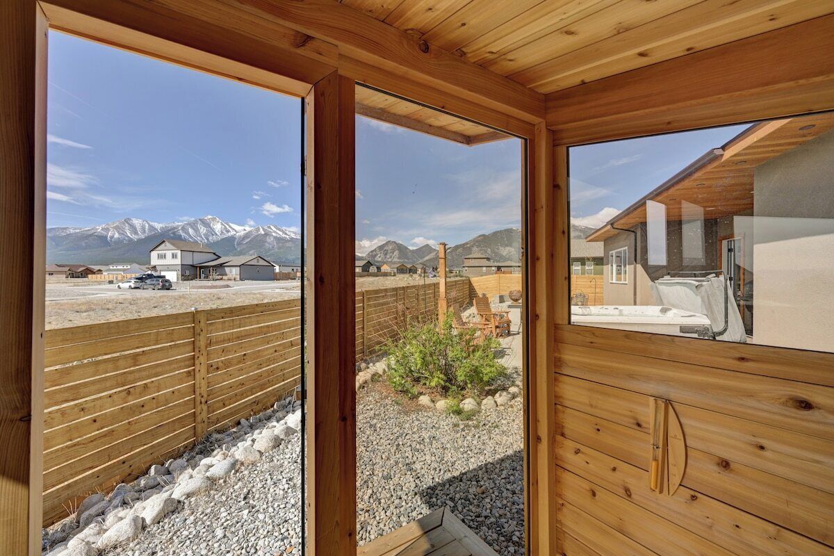 A wooden cabin with a view of a mountain range.