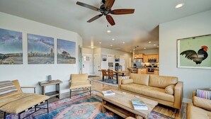 A spacious living room with a ceiling fan, a large sofa, a coffee table, and a colorful rug. - Mountain Haven Retreat w/Hot Tub & Sauna STR-283 (Buena Vista)