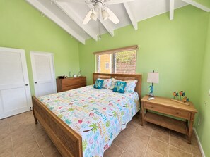 A bedroom with a bed, dresser, nightstand, and a ceiling fan. - Shore Blessed! 2 bedroom, 2 Bathroom villa with private pool! (Christiansted)