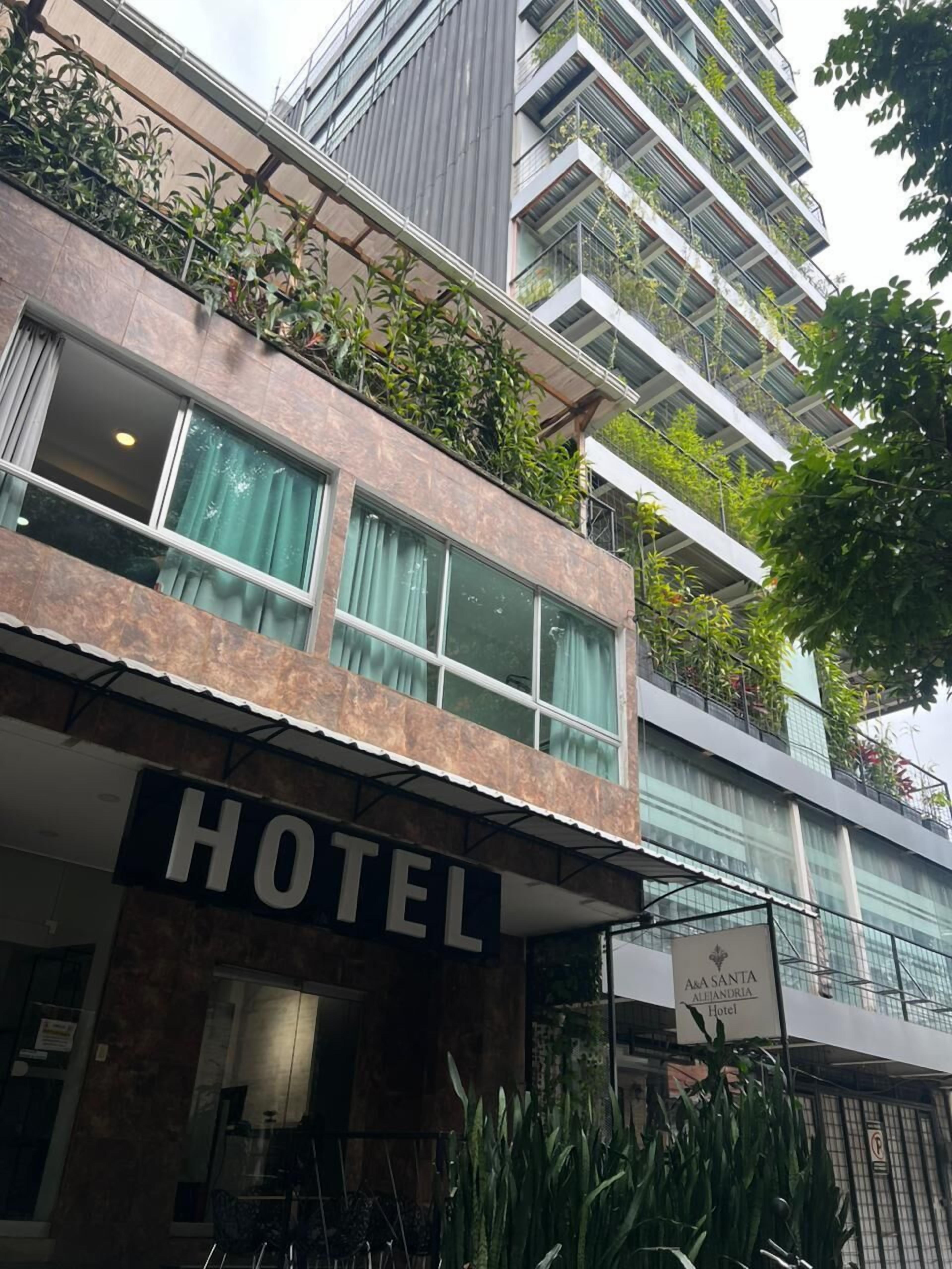 A hotel with a sign reading "HOTEL" and "A&A SANTA ALEJANDRIA Hotel".